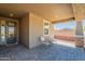 Covered patio with tiled flooring offering a cozy seating area, perfect for relaxing outdoors at 13455 N 142Nd Ave, Surprise, AZ 85379