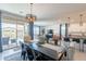 Bright dining room with a view of the backyard pool, modern light fixture and contemporary decor at 13455 N 142Nd Ave, Surprise, AZ 85379