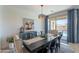 Dining room with dark table, chairs, buffet, chandelier, and sliding doors to the outdoor pool at 13455 N 142Nd Ave, Surprise, AZ 85379