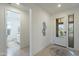 Bright foyer with a decorative mirror and tiled flooring leads to a full bath and living areas at 13455 N 142Nd Ave, Surprise, AZ 85379