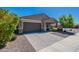 Charming single-story home with a desert front yard, a two-car garage, and a welcoming entrance at 13455 N 142Nd Ave, Surprise, AZ 85379