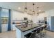 Modern kitchen with white cabinets, granite countertops, stainless steel appliances, and pendant lighting at 13455 N 142Nd Ave, Surprise, AZ 85379