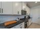 Gourmet kitchen with granite countertops, a tile backsplash, and stainless steel appliances at 13455 N 142Nd Ave, Surprise, AZ 85379