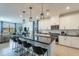 Open kitchen with island seating, stainless appliances, and a view into the living area at 13455 N 142Nd Ave, Surprise, AZ 85379