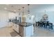Bright, open kitchen with a large island, stainless steel appliances, and sight lines into the dining room at 13455 N 142Nd Ave, Surprise, AZ 85379