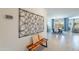 Spacious living area with stylish decor, complemented by a wooden bench and art installation at 13455 N 142Nd Ave, Surprise, AZ 85379