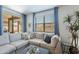 Inviting living room space with a comfortable sectional sofa and bright natural light from windows at 13455 N 142Nd Ave, Surprise, AZ 85379