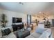 Spacious living room with modern decor, a large television, and an open floor plan at 13455 N 142Nd Ave, Surprise, AZ 85379