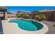 Sparkling pool with lush landscaping, desert plants, and a privacy wall providing a serene backyard retreat at 13455 N 142Nd Ave, Surprise, AZ 85379
