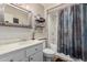 Bathroom featuring a white vanity, toilet, and shower with blue patterned curtain at 14212 N Newcastle Dr, Sun City, AZ 85351