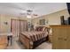 Comfortable bedroom featuring a ceiling fan and a wood bed frame with striped bedding at 14212 N Newcastle Dr, Sun City, AZ 85351