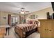 Comfortable bedroom featuring a ceiling fan and sliding glass door to the back patio at 14212 N Newcastle Dr, Sun City, AZ 85351