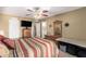 Bedroom features a TV, dresser, sliding glass door to the backyard, and access to a bathroom at 14212 N Newcastle Dr, Sun City, AZ 85351