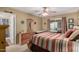 Bedroom featuring a ceiling fan, dresser, and sliding glass door to the backyard at 14212 N Newcastle Dr, Sun City, AZ 85351