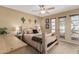 Bedroom featuring a ceiling fan, windows, wood accents, and Southwestern-themed décor at 14212 N Newcastle Dr, Sun City, AZ 85351