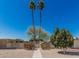 Inviting community entrance with palm trees and desert landscaping at 14212 N Newcastle Dr, Sun City, AZ 85351