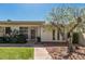 Charming single-story home featuring a well-manicured lawn, mature tree, and inviting walkway at 14212 N Newcastle Dr, Sun City, AZ 85351