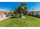 Well-manicured green space with mature trees between buildings, offering a tranquil setting at 14212 N Newcastle Dr, Sun City, AZ 85351