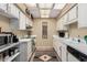 Functional kitchen featuring white cabinets, laminate countertops, and essential appliances at 14212 N Newcastle Dr, Sun City, AZ 85351