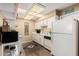 Bright kitchen offering essential appliances, white cabinets, and ample countertop space at 14212 N Newcastle Dr, Sun City, AZ 85351