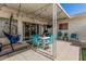 Charming covered patio with string lights, outdoor furniture, and sliding glass door access at 14212 N Newcastle Dr, Sun City, AZ 85351