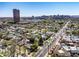 Expansive aerial view of a residential neighborhood with city skyline in the background on a clear day at 144 W Palm Ln, Phoenix, AZ 85003