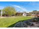 Expansive backyard with lush lawn, mature landscaping, and charming outdoor seating area at 144 W Palm Ln, Phoenix, AZ 85003