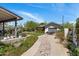 An expansive backyard with lush landscaping, a cozy seating area, and a charming stone pathway at 144 W Palm Ln, Phoenix, AZ 85003
