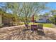 Charming backyard with shade tree offering an inviting outdoor dining space at 144 W Palm Ln, Phoenix, AZ 85003