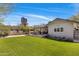 Beautiful backyard featuring a covered patio, well-maintained lawn, and convenient access to outdoor living spaces at 144 W Palm Ln, Phoenix, AZ 85003
