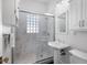 Bright bathroom featuring a glass-enclosed shower and pedestal sink at 144 W Palm Ln, Phoenix, AZ 85003