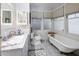 Bright bathroom featuring a clawfoot tub, marble countertop, and tiled flooring at 144 W Palm Ln, Phoenix, AZ 85003