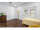 Bright room featuring a twin bed, stained concrete floors, and paneled doors at 144 W Palm Ln, Phoenix, AZ 85003