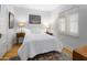 Cozy bedroom with natural light, hardwood floors, and a patterned rug at 144 W Palm Ln, Phoenix, AZ 85003