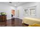Bright room featuring a twin bed, stained concrete floors, access to the garage, and paneled doors at 144 W Palm Ln, Phoenix, AZ 85003