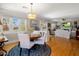 Open-concept dining and living area with hardwood floors and natural light at 144 W Palm Ln, Phoenix, AZ 85003