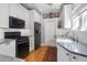 Bright kitchen featuring white cabinets, subway tile backsplash, and stainless steel appliances at 144 W Palm Ln, Phoenix, AZ 85003