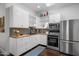 Well-lit kitchen with white cabinets, wood countertop and stainless steel appliances at 144 W Palm Ln, Phoenix, AZ 85003