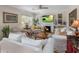 Bright living room featuring white couches, a fireplace, and a ceiling fan at 144 W Palm Ln, Phoenix, AZ 85003