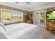 Bright main bedroom with white bedding, window view and access to the outdoor patio at 144 W Palm Ln, Phoenix, AZ 85003