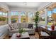 Bright sunroom with large windows, hardwood floors, and comfortable seating at 144 W Palm Ln, Phoenix, AZ 85003