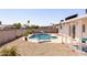 Inviting backyard featuring a sparkling pool, lounge chairs, and a covered patio area at 14803 N 55Th Ave, Glendale, AZ 85306