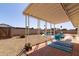 Charming backyard patio with a shaded seating area, lush plants, and a view of the sparkling pool at 14803 N 55Th Ave, Glendale, AZ 85306