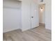 A bedroom features light wood-look flooring and a closet with a hanging rod for organizing clothing at 14803 N 55Th Ave, Glendale, AZ 85306