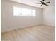 Clean, modern bedroom with neutral walls, new flooring, and a large window for natural light at 14803 N 55Th Ave, Glendale, AZ 85306