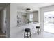 Open-concept kitchen with bar seating, granite countertops, and updated appliances at 14803 N 55Th Ave, Glendale, AZ 85306