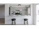 Kitchen with bar seating area, white cabinets, and modern finishes at 14803 N 55Th Ave, Glendale, AZ 85306