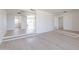 Open-concept living room with step-up platform and neutral flooring, bathed in natural light at 14803 N 55Th Ave, Glendale, AZ 85306