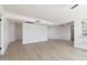 Bright living room with new flooring, neutral walls, and an open layout leading into the kitchen at 14803 N 55Th Ave, Glendale, AZ 85306