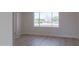 Bright, empty living room with wood floors and a large window overlooking the street at 14803 N 55Th Ave, Glendale, AZ 85306